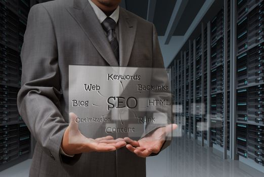 business man hand shows virtual screen of SEO diagram