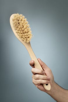 Bath brush made of wood and natural fibers.