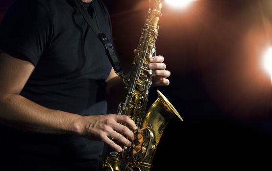 Musician playing alto saxophone on a gig.