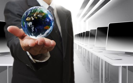Business man hand holds globe and social network"Elements of this image furnished by NASA"