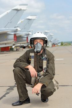 military pilot in a helmet near the aircraft