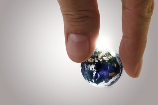 globe in fingers"Elements of this image furnished by NASA"