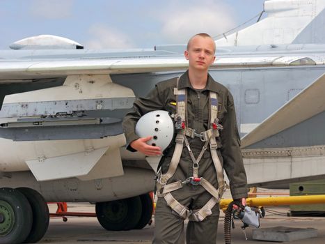 military pilot in a helmet near the aircraft