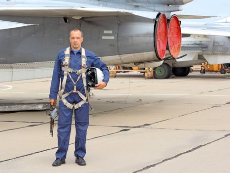 military pilot in a helmet near the aircraft