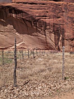 Image of fence with cliff in background.