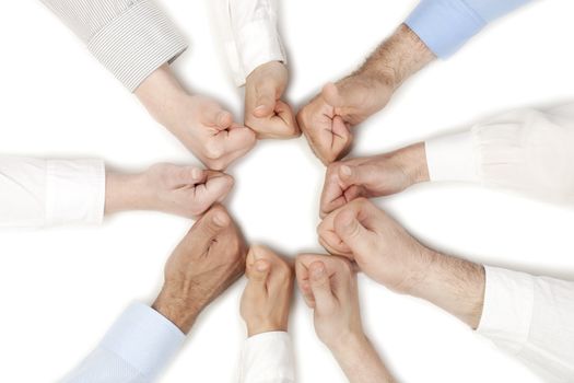 Group of human fists forming a circle shape isolated in a white background