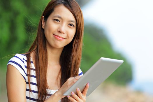 young asian woman with tablet outdoor
