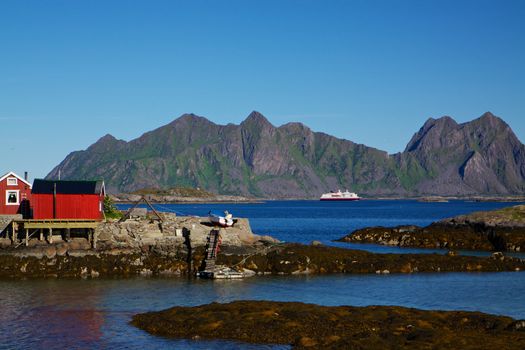 Fishing house on tiny islets on the coast of Lofoten islands in Norway
