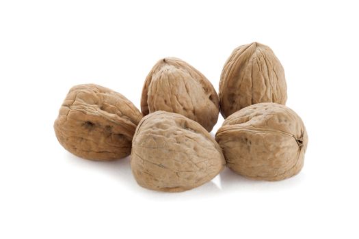 Close-up image of five walnuts isolated on a white background