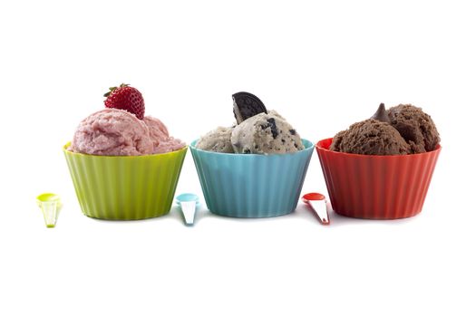 Three different flavor ice cream with toppings arranged horizontally on the white background