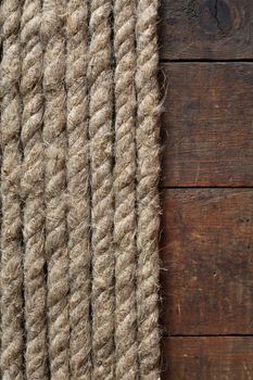 Old hemp rope on dark wooden surface