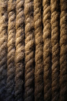 Extreme closeup of old rope background under beam of light