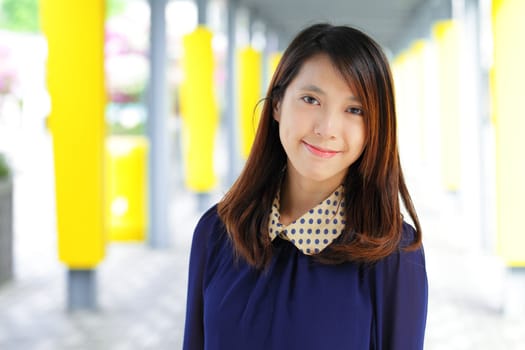 young woman smiling friendly on street