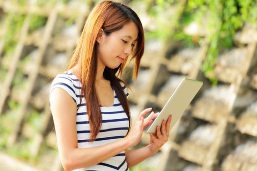 young asian woman with tablet computer outdoor