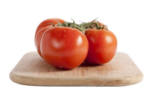Red tomatoes on a chopping board