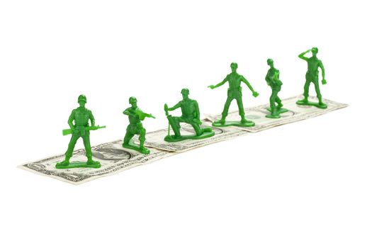 Toy Soldiers standing on a dollar isolated on 