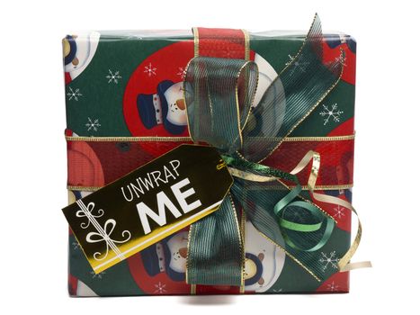 Close-up front shot of a Christmas gift box with unwrap me placard.