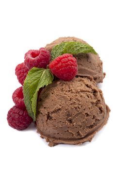 Close up image of a fruity chocolate ice cream with mint leafs and strawberries