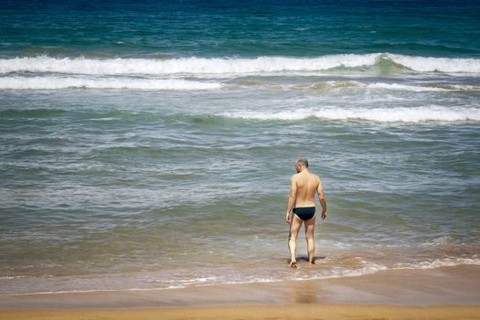 An image of a handsome man at the beach