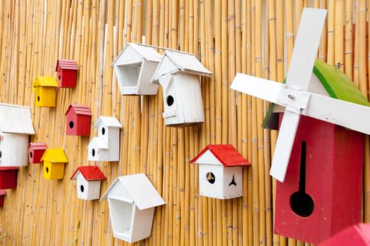 Colorful collection of birdhouses on wood wall