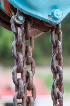 Old iron chain tie on the metal bar.