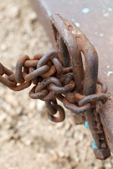 Old iron chain tie on the metal bar.