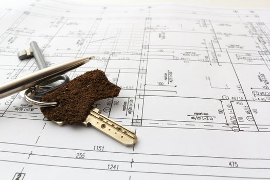 keys and pen over blueprint of house for contract