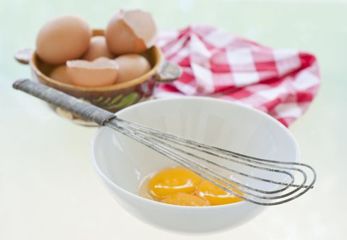 Antique whisk to be used to whip a bowl of raw egg yolks.