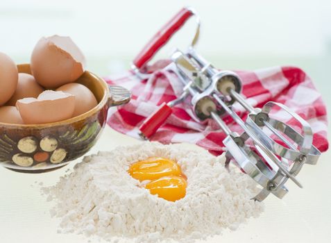 Still life photography of several different baking ingredients and utensils.