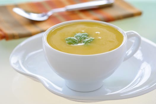 Cup of delicious homemade creamy squash soup.