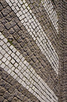 Path paved with small stones. Architectural background of floor.