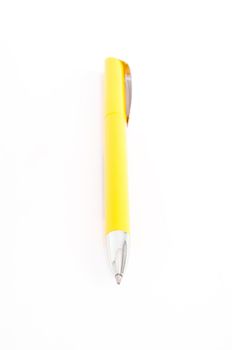 Yellow pen closeup on the white background