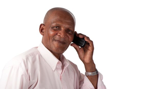 A happy senior man communicates on his cellular phone.