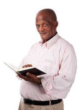 A senior person holds a holy or text book in his hands.