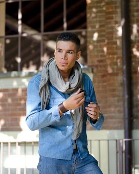 Good looking male model with scarf and jeans garment