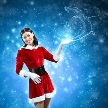 Portrait of beautiful girl wearing santa claus clothes on red background