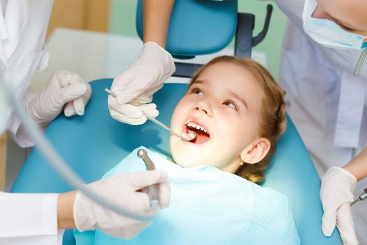 Little girl sitting in the dentists office