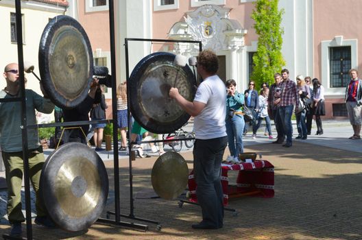 VILNIUS, LITHUANIA - MAY 19: unidentified people play Kong - Thai traditional musical instrument on May 19, 2012 in Vilnius. It is formally used in majestic and religious ceremonies. Street music day.