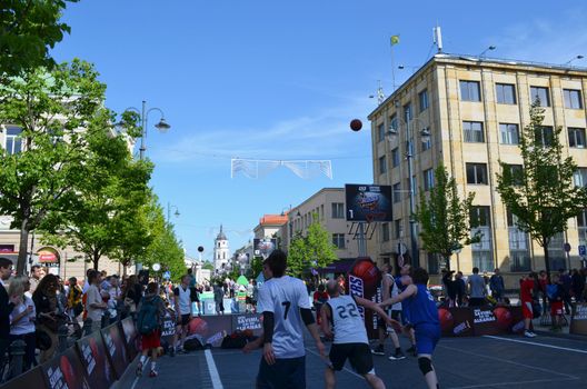 VILNIUS, LITHUANIA - MAY 19: unidentified people play basketball in Gediminas prospect on May 19, 2012 in Vilnius. Outside street basketball tournament 3x3.