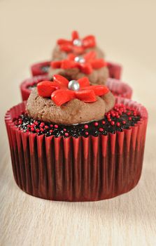 Delicious chocolate cupcakes in red