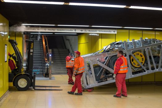 STUTTGART - OCTOBER 24: Workers are installing a new escalator during renovation works in the metropolitan railway station Schwabstraße using a forklift in the late evening of October 24, 2012 in Stuttgart, Germany