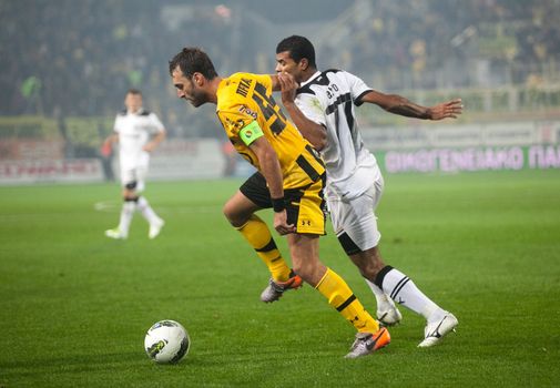 THESSALONIKI, GREECE - OCTOBER 23: Claiming the ball between players Sakis Prittas, Oelilton Etto Araujo dos Santos in football match between Paok and Aris (1-1) on October 23, 2011 in Thessaloniki, Greece