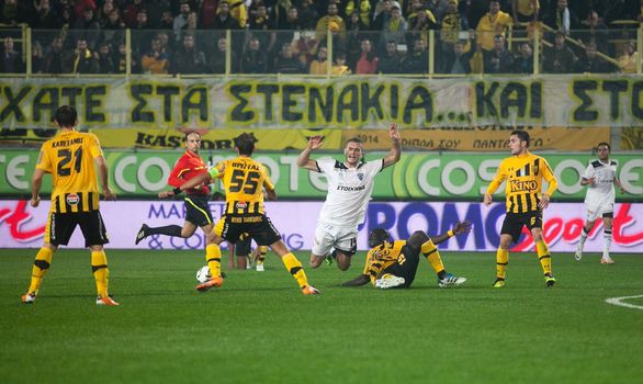 THESSALONIKI, GREECE - OCTOBER 23: Claiming the ball between players Papazoglou, Sakis Prittas, Khalifa Sankare in football match between Paok and Aris (1-1) on October 23, 2011 in Thessaloniki, Greece