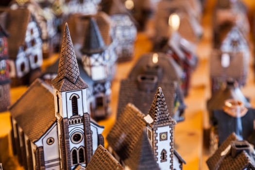 Specific Alsacian miniature ceramic houses on a sovenirs market stand in Alsace, France.