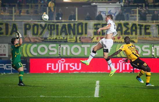 THESSALONIKI, GREECE - OCTOBER 23: Athanasios Papazoglou passes the Khalifa Sankare and scores for the Paok. Markos Vellidis the goalkeeper. Paok and Aris (1-1) on October 23, 2011 in Thessaloniki, Greece
