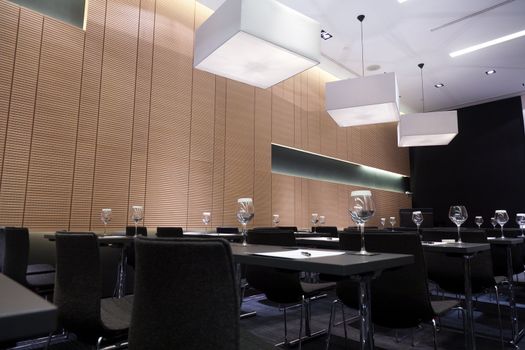 Meeting room interior with table, raw of chairs and block-notes,decorat ed in black and white tones