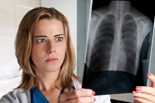 Worried female doctor looking at an x-ray