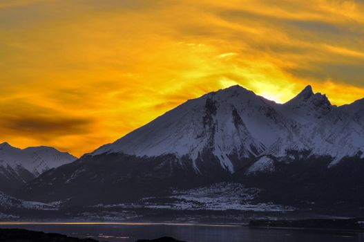 An orange sky at sunset behind a mountain in Tierra del Fuego.