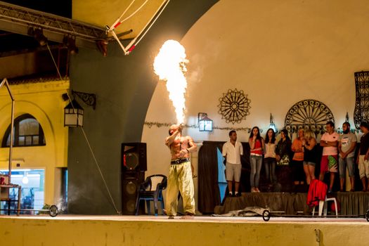 Spectacular show at an outdoor stage in Hammamet, Tunisia, where Local talent showcase their extraordinary ability to breathe fire like the mystical fire breathing dragons.