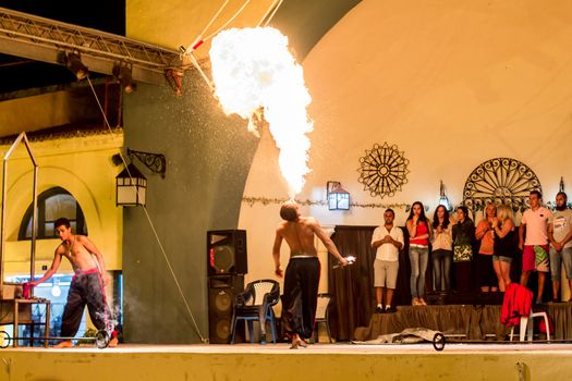Spectacular show at an outdoor stage in Hammamet, Tunisia, where Local talent showcase their extraordinary ability to breathe fire like the mystical fire breathing dragons.